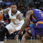 Denver Nuggets guard D.J. Augustin, back, drives the lane for a shot as Phoenix Suns guard Brandon Knight defends in the second half of an NBA basketball game Thursday, March 10, 2016, in Denver.  (AP Photo/David Zalubowski)