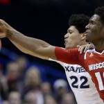 Wisconsin's Nigel Hayes (10) and Xavier's Kaiser Gates (22) chase the ball during the first half of a second-round men's college basketball game in the NCAA Tournament, Sunday, March 20, 2016, in St. Louis. (AP Photo/Charlie Riedel)