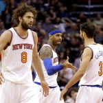 New York Knicks' Carmelo Anthony, center, is congratulated by teammate Jose Calderon (3) as Robin Lopez walks to the bench against the Phoenix Suns during the first half of an NBA basketball game Wednesday, March 9, 2016, in Phoenix. (AP Photo/Matt York)