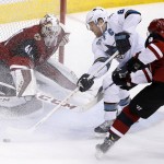 Arizona Coyotes' Mike Smith (41) slides over to make a save on a shot by San Jose Sharks' Joe Pavelski (8) as Coyotes' Viktor Tikhonov (9), of Russia, defends during the third period of an NHL hockey game Thursday, March 17, 2016, in Glendale, Ariz. The Coyotes defeated the Sharks 3-1. (AP Photo/Ross D. Franklin)