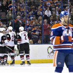 Arizona Coyotes' players Antoine Vermette (50), Shane Doan (19), Michael Stone (26) and Nicklas Grossman (2) celebrate a goal as Edmonton Oilers' Taylor Hall (4) skates past during the second period of an NHL hockey game in Edmonton, Alberta, Saturday, March 12, 2016. (Jason Franson/The Canadian Press via AP) MANDATORY CREDIT