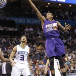 Phoenix Suns' Archie Goodwin (20) shoots as Charlotte Hornets' Jeremy Lamb (3) watches during the first half of an NBA basketball game in Charlotte, N.C., Tuesday, March 1, 2016. (AP Photo/Chuck Burton)
