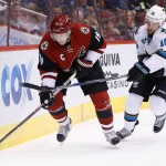 Arizona Coyotes' Shane Doan (19) tries to skate with the puck as San Jose Sharks' Nick Spaling (16) arrives to hit Doan with his stick during the first period of an NHL hockey game Thursday, March 17, 2016, in Glendale, Ariz. (AP Photo/Ross D. Franklin)