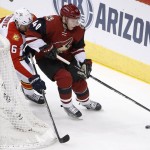Arizona Coyotes' Alex Tanguay (40) tries to keep the puck away from Florida Panthers' Alex Petrovic (6) during the first period of an NHL hockey game Saturday, March 5, 2016, in Glendale, Ariz. (AP Photo/Ross D. Franklin)