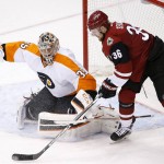 Philadelphia Flyers' Steve Mason (35) blocks the puck on a shot by Arizona Coyotes' Jiri Sekac (36), of the Czech Republic, during the first period of an NHL hockey game Saturday, March 26, 2016, in Glendale, Ariz. (AP Photo/Ross D. Franklin)