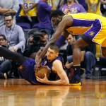 Phoenix Suns center Alex Len, left, looks to pass the ball as Los Angeles Lakers center Roy Hibbert, right, during the first half of an NBA basketball game, Wednesday, March 23, 2016, in Phoenix. (AP Photo/Matt York)