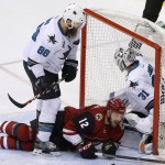 San Jose Sharks' Martin Jones (31) gives up a goal to Arizona Coyotes' Shane Doan as Sharks' Brent Burns (88) shoves Coyotes' Brad Richardson (12) into the goalie during the third period of an NHL hockey game Thursday, March 17, 2016, in Glendale, Ariz. The Coyotes defeated the Sharks 3-1. (AP Photo/Ross D. Franklin)