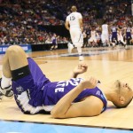 Weber State guard Ryan Richardson lies injured on the court as play continues during the first half of an NCAA college basketball game against Xavier in the NCAA men's tournament, Friday, March 18, 2016, in St. Louis. (Chris Lee/St. Louis Post-Dispatch via AP)
