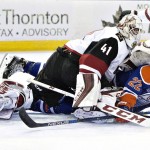 Edmonton Oilers' Adam Cracknell (22) crashes into Arizona Coyotes' goalie Mike Smith (41) during the second period of an NHL hockey game in Edmonton, Alberta, Saturday, March 12, 2016. (Jason Franson/The Canadian Press via AP) MANDATORY CREDIT