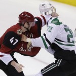 Arizona Coyotes defenseman Alex Grant (47) fights with Dallas Stars center Colton Sceviour (22) during the second period of an NHL hockey game Thursday, March 31, 2016, in Dallas. (AP Photo/LM Otero)