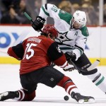 Dallas Stars' Vernon Fiddler (38) and Arizona Coyotes' Boyd Gordon (15) battle on a face off during the first period of an NHL hockey game, Thursday, March 24, 2016, in Glendale, Ariz. (AP Photo/Ross D. Franklin)