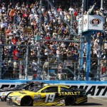 Kevin Harvick, left, beats Carl Edwards, right, at the finish line during a NASCAR Sprint Cup Series auto race at Phoenix International Raceway, Sunday, March 13, 2016, in Avondale, Ariz. (AP Photo/Ross D. Franklin)