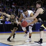 Wichita State guards Fred VanVleet, left, and Evan Wessel, right, pressure Arizona forward Ryan Anderson, center, during the second half of a game in the first round of the NCAA men's college basketball tournament in Providence, R.I., Thursday, March 17, 2016. Wichita State defeated Arizona 65-55. (AP Photo/Charles Krupa)