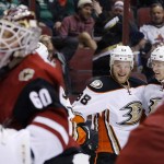 Anaheim Ducks' Jamie McGinn (88) smiles as he celebrates his goal against Arizona Coyotes' Niklas Treutle (60), of Germany, with teammate Corey Perry (10) during the first period of an NHL hockey game Thursday, March 3, 2016, in Glendale, Ariz. (AP Photo/Ross D. Franklin)