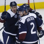 Colorado Avalanche center Shawn Matthias, left, celebrates scoring a goal with defenseman Nick Holden against the Arizona Coyotes in the first period of an NHL hockey game, Monday, March 7, 2016, in downtown Denver. (AP Photo/David Zalubowski)