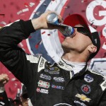 Kevin Harvick finishes off a beer as he crushes the can as he celebrates in victory lane after winning a NASCAR Sprint Cup Series auto race at Phoenix International Raceway, Sunday, March 13, 2016, in Avondale, Ariz. (AP Photo/Ross D. Franklin)