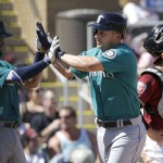 Seattle Mariners third baseman Kyle Seager, center, celebrates after hitting a 2-run home run that scored Luis Sardinas, left, during the third inning of a spring training baseball game against the Arizona Diamondbacks in Scottsdale, Ariz., Monday, March 14, 2016. Pictured at right is Diamondbacks catcher Tuffy Gosewisch. (AP Photo/Jeff Chiu)