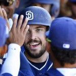 San Diego Padres' Austin Hedges celebrates his two-run home run against the Arizona Diamondbacks in the dugout with teammates during the second inning of a spring training baseball game, Tuesday, March 8, 2016, in Peoria, Ariz. The game ended in an 8-8 tie. (AP Photo/Ross D. Franklin)