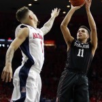 Stanford guard Dorian Pickens (11) shoots over Arizona guard Gabe York during the first half of an NCAA college basketball game, Saturday, March 5, 2016, in Tucson, Ariz. (AP Photo/Rick Scuteri)