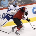 Tampa Bay Lightning goalie Ben Bishop (30) tangles with Arizona Coyotes' Brad Richardson, right, during the second period of an NHL hockey game Saturday, March 19, 2016, in Glendale, Ariz. (AP Photo/Ross D. Franklin)