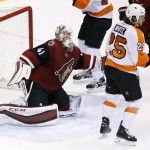 Arizona Coyotes' Mike Smith (41) gives up a goal to Philadelphia Flyers' Sean Couturier as Flyers' Ryan White (25) looks for the celebration during the third period of an NHL hockey game Saturday, March 26, 2016, in Glendale, Ariz. The Coyotes defeated the Flyers 2-1. (AP Photo/Ross D. Franklin)