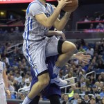 Orlando Magic guard Evan Fournier, front, goes up for a shot in front of Phoenix Suns forward Jon Leuer during the first half of an NBA basketball game in Orlando, Fla., Friday, March 4, 2016. (AP Photo/Phelan M. Ebenhack)