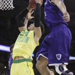 Oregon forward Dillon Brooks (24) shoots against of Holy Cross forward Eric Green, right, during the first half of a first-round men's college basketball game in the NCAA Tournament in Spokane, Wash., Friday, March 18, 2016. (AP Photo/Young Kwak)