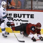 San Jose Sharks' Justin Braun, left, trips up Arizona Coyotes' Sergei Plotnikov, of Russia, during the third period of an NHL hockey game Thursday, March 17, 2016, in Glendale, Ariz. The Coyotes defeated the Sharks 3-1. (AP Photo/Ross D. Franklin)