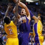 Phoenix Suns forward Jon Leuer (30) shoots over Los Angeles Lakers forward Brandon Bass (2) during the second half of an NBA basketball game,Wednesday, March 23, 2016, in Phoenix. The Suns won 119-107. (AP Photo/Matt York)