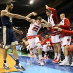 Pittsburgh forward Alonzo Nelson-Ododa, left, and the Wisconsin bench point at each other as the ball goes out of bounds off of Nelson-Ododa during the first half of a college basketball game in the NCAA men's tournament, Friday, March 18, 2016, in St. Louis. Wisconsin won 47-43. (Chris Lee/St. Louis Post-Dispatch via AP)