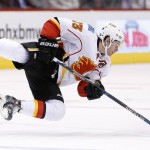 Calgary Flames' Sean Monahan falls to the ice after trying to change direction and keep control of the puck during the first period of an NHL hockey game against the Arizona Coyotes, Monday, March 28, 2016, in Glendale, Ariz. (AP Photo/Ross D. Franklin)