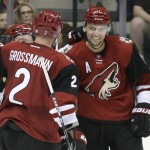 Arizona Coyotes center Martin Hanzal (11) celebrates his goal with teammates Nicklas Grossmann (2) and Max Domi during the first period of an NHL hockey game against the Dallas Stars on Thursday, March 31, 2016, in Dallas. (AP Photo/LM Otero)