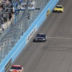 Kyle Busch, front, leads Cole Whitt, middle, and Carl Edwards during a NASCAR Sprint Cup Series auto race at Phoenix International Raceway on Sunday, March 13, 2016, in Avondale, Ariz. (AP Photo/Ross D. Franklin)