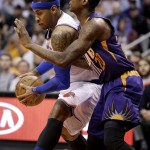 New York Knicks' Carmelo Anthony, left, drives against Phoenix Suns' Archie Goodwin during the first half of an NBA basketball game Wednesday, March 9, 2016, in Phoenix. (AP Photo/Matt York)