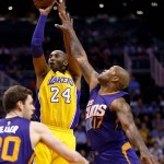 Los Angeles Lakers forward Kobe Bryant (24) shoots over Phoenix Suns forward P.J. Tucker (17) during the first half of an NBA basketball game, Wednesday, March 23, 2016, in Phoenix. (AP Photo/Matt York)