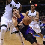 Phoenix Suns guard Devin Booker, right, is fouled by Milwaukee Bucks center Greg Monroe, left, during the second half of an NBA basketball game Wednesday, March 30, 2016, in Milwaukee. (AP Photo/Darren Hauck)