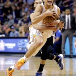 Phoenix Suns' Devin Booker, front, is fouled by Minnesota Timberwolves' Zach LaVine during the second half of an NBA basketball game, Monday, March 14, 2016, in Phoenix. The Suns won 107-104. (AP Photo/Matt York)