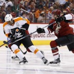 Arizona Coyotes' Connor Murphy, right, tries to slap the puck away from Philadelphia Flyers' Wayne Simmonds (17) during the second period of an NHL hockey game Saturday, March 26, 2016, in Glendale, Ariz. (AP Photo/Ross D. Franklin)