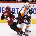 Philadelphia Flyers' Jakub Voracek (93), of the Czech Republic, checks Arizona Coyotes' Klas Dahlbeck (34), of Sweden, to the ice during the first period of an NHL hockey game Saturday, March 26, 2016, in Glendale, Ariz. (AP Photo/Ross D. Franklin)