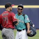 Arizona Diamondbacks' Carlos Rivero, left, and Seattle Mariners' Luis Sardinas, right, talk in the outfield before a spring training baseball game Monday, March 7, 2016, in Peoria, Ariz. (AP Photo/Charlie Riedel)