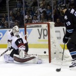 Arizona Coyotes goalie Mike Smith (41) is beaten for a goal on a shot from San Jose Sharks' Brenden Dillon, not seen, as the Sharks' Joe Thornton (19) looks on during the first period of an NHL hockey game Sunday, March 20, 2016, in San Jose, Calif. (AP Photo/Marcio Jose Sanchez)