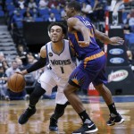 Minnesota Timberwolves guard Tyus Jones (1) drives against Phoenix Suns guard Ronnie Price, right, during the second half of an NBA basketball game in Minneapolis, Monday, March 28, 2016. The Timberwolves won 121-116. (AP Photo/Ann Heisenfelt)