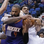 Phoenix Suns center Tyson Chandler (4) and Minnesota Timberwolves center Karl-Anthony Towns, right, wrestle for a rebound during the second half of an NBA basketball game in Minneapolis, Monday, March 28, 2016. The Timberwolves won 121-116. (AP Photo/Ann Heisenfelt)