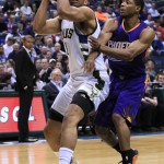 Milwaukee Bucks guard Khris Middleton, left, is defended by Phoenix Suns guard Brandon Knight, right, during the first half of an NBA basketball game Wednesday, March 30, 2016, in Milwaukee. (AP Photo/Darren Hauck)