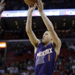 Phoenix Suns guard Devin Booker (1) shoots for three points against the Miami Heat during the first half of an NBA basketball game, Thursday, March 3, 2016, in Miami. (AP Photo/Alan Diaz)