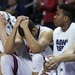 Arizona players cover their heads in the closing minute against Wichita State during the first round of the NCAA college men's basketball tournament in Providence, R.I., Thursday, March 17, 2016. Wichita State defeated Arizona 65-55. (AP Photo/Charles Krupa)