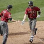 Arizona Diamondbacks' Brandon Drury (27) celebrates with Nick Ahmed (13) after Drury hit a two-run home run during the fourth inning of a spring training baseball game Monday, March 7, 2016, in Peoria, Ariz. (AP Photo/Charlie Riedel)