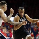 Stanford forward Cameron Walker, right, drives against Arizona guard Gabe York during the first half of an NCAA college basketball game, Saturday, March 5, 2016, in Tucson, Ariz. (AP Photo/Rick Scuteri)