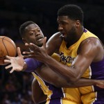 Los Angeles Lakers center Roy Hibbert, right, and forward Julius Randle scramble for a rebound during the first half of an NBA basketball game against the Phoenix Suns in Los Angeles, Friday, March 18, 2016. (AP Photo/Chris Carlson)