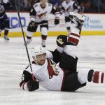 Arizona Coyotes center Max Domi loses his edge while driving with the puck against the Colorado Avalanche in the second period of an NHL hockey game, Monday, March 7, 2016, in Denver. (AP Photo/David Zalubowski)